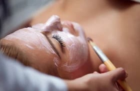 Newborn baby sleeping peacefully in adult hands, close-up portrait showing gentle care